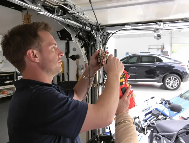New Albany Garage Door Repair safety certified technician performing cable replacement in New Albany
